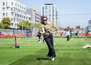 woman playing red ball tennis