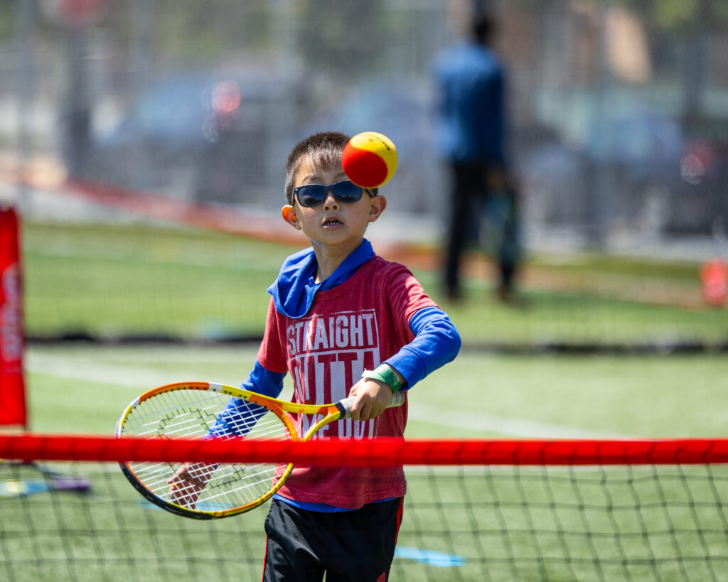 kid playing red ball